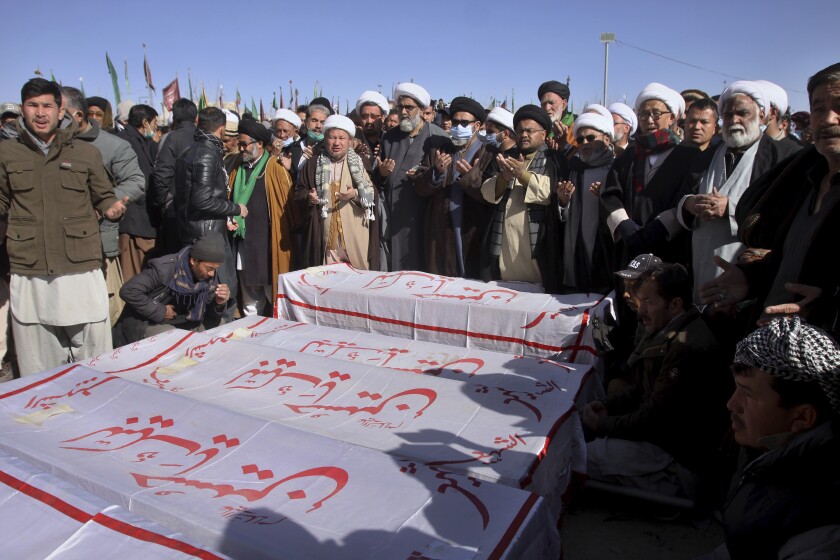 People attend the funeral prayer of coal mine workers who were killed by gunmen near the Machh coal field in Quetta, Pakistan, Saturday, Jan. 9, 2021. Hundreds of Pakistani Shiites gathered to bury 11 coal miners from the minority Hazara community who were killed by the Islamic State group, ending over a week of protests that sought to highlight the minority community's plight. (AP Photo/Arshad Butt)