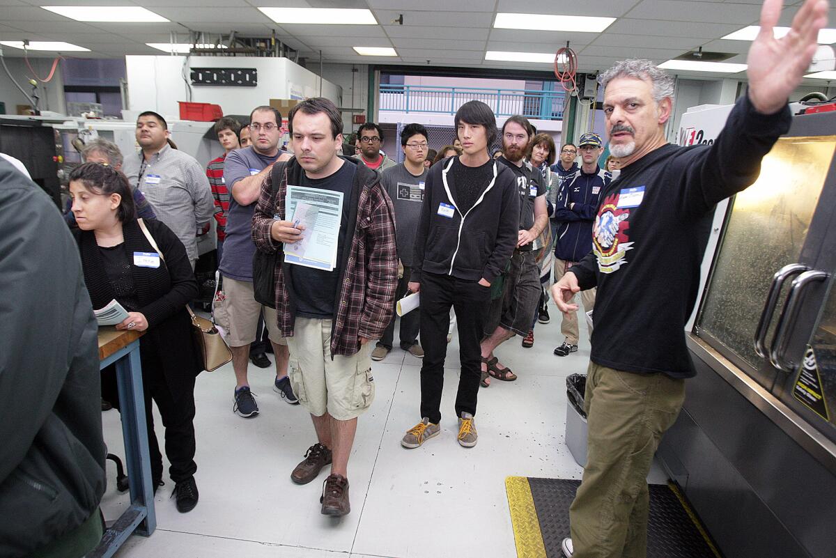 Aram Ohanis, chair for Glendale Community College's manufacturing department, directs students to the next presentation in the Engineering Design Manuafacturing HUB at an information meeting for a brand new program called the Uniquely Abled Academy at Glendale Community College on Thursday, May 5, 2016. The academy trains high-functioning adults with autism how to use a CNC machine.