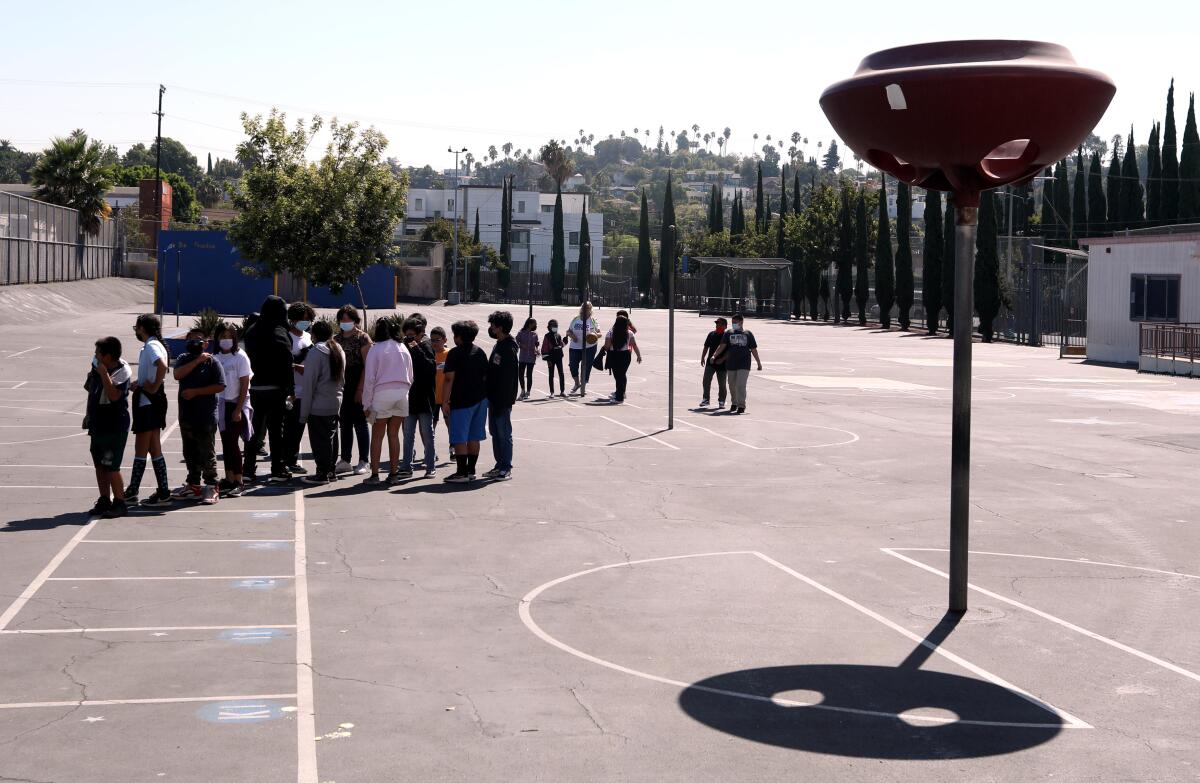 Students on unshaded pavement prepare to return to class after a morning recess at Lockwood Elementary School in L.A.