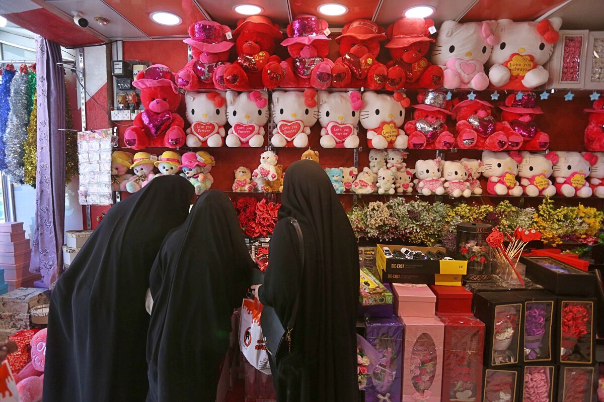 In this Thursday, Feb. 13, 2020 photo, women shop for Valentine's Day gifts in Najaf, Iraq. In recent years, Valentine's in Najaf has emerged as a field of contention. It pitted revelers who see in it harmless fun and personal freedom advocates against conservatives who view it as sacrilege--a foreign celebration that has no place in a holy city like Najaf. (AP Photo/Anmar Khalil)