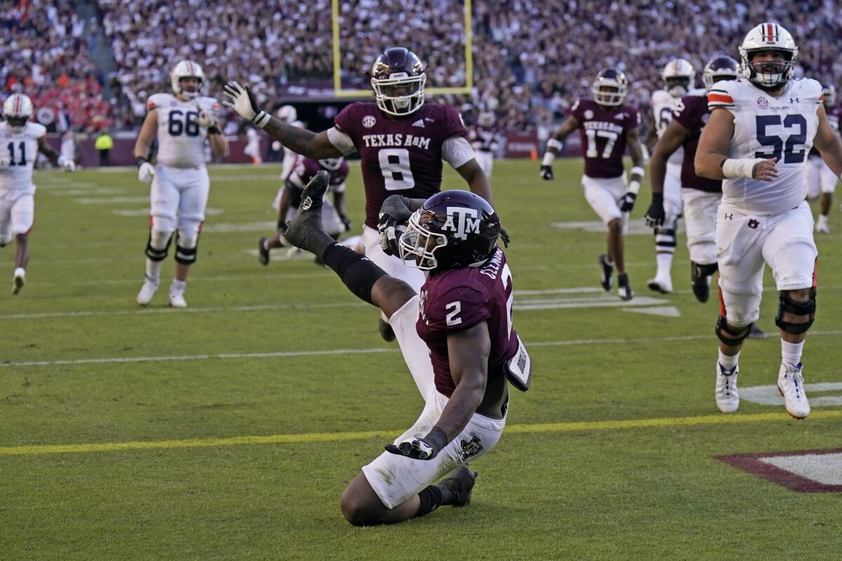 Texas A&M defensive lineman Micheal Clemons (2) falls into the end zone for a touchdown after recovering a fumble by Auburn quarterback Bo Nix during the second half of an NCAA college football game Saturday, Nov. 6, 2021, in College Station, Texas. Texas A&M won 20-3. (AP Photo/David J. Phillip)