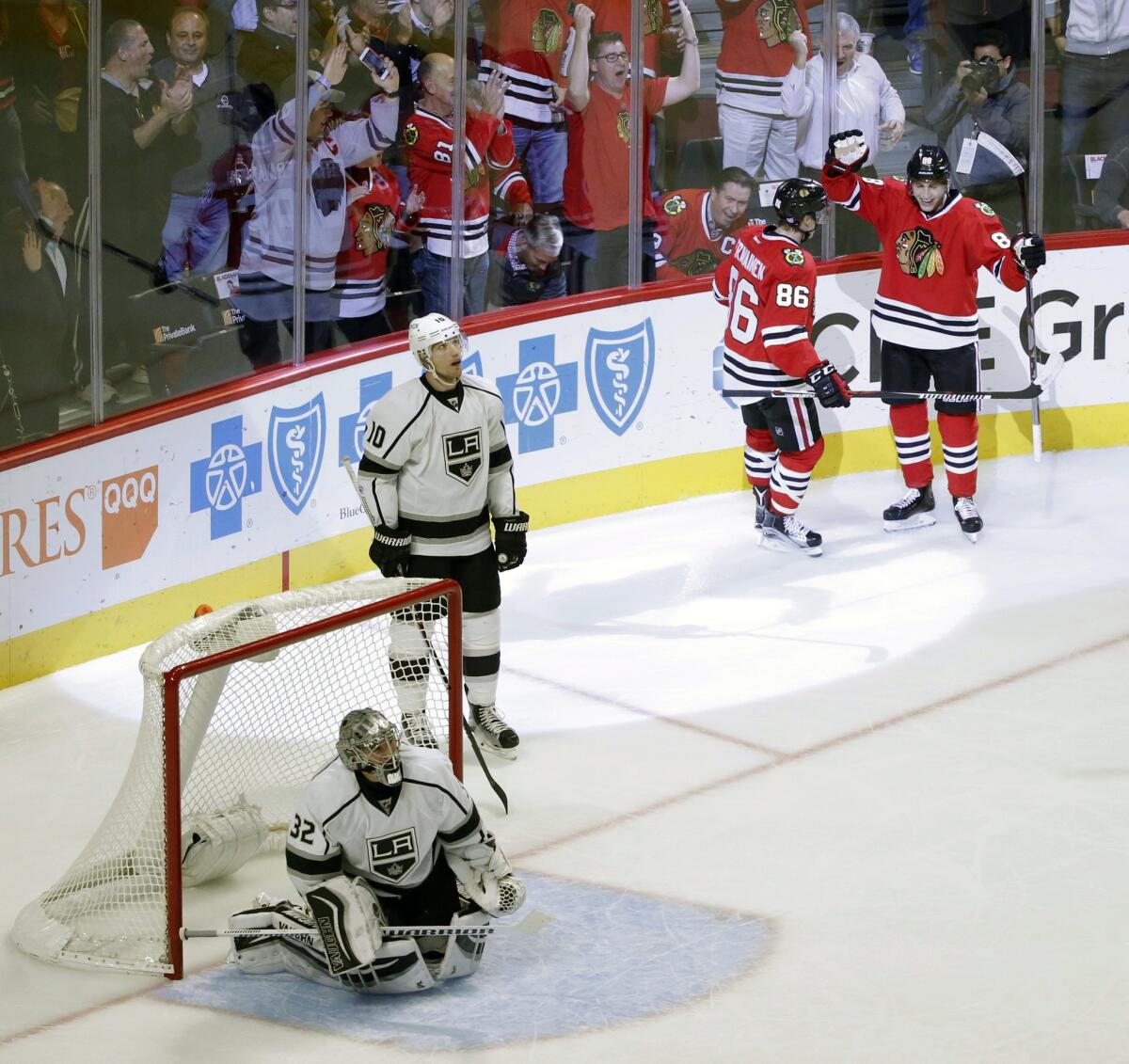 Blackhawks left wing Teuvo Teravainen (86) celebrates his goal with Patrick Kane (88) as Kings defender Christian Ehrhoff (10) watches a replay during the third period.