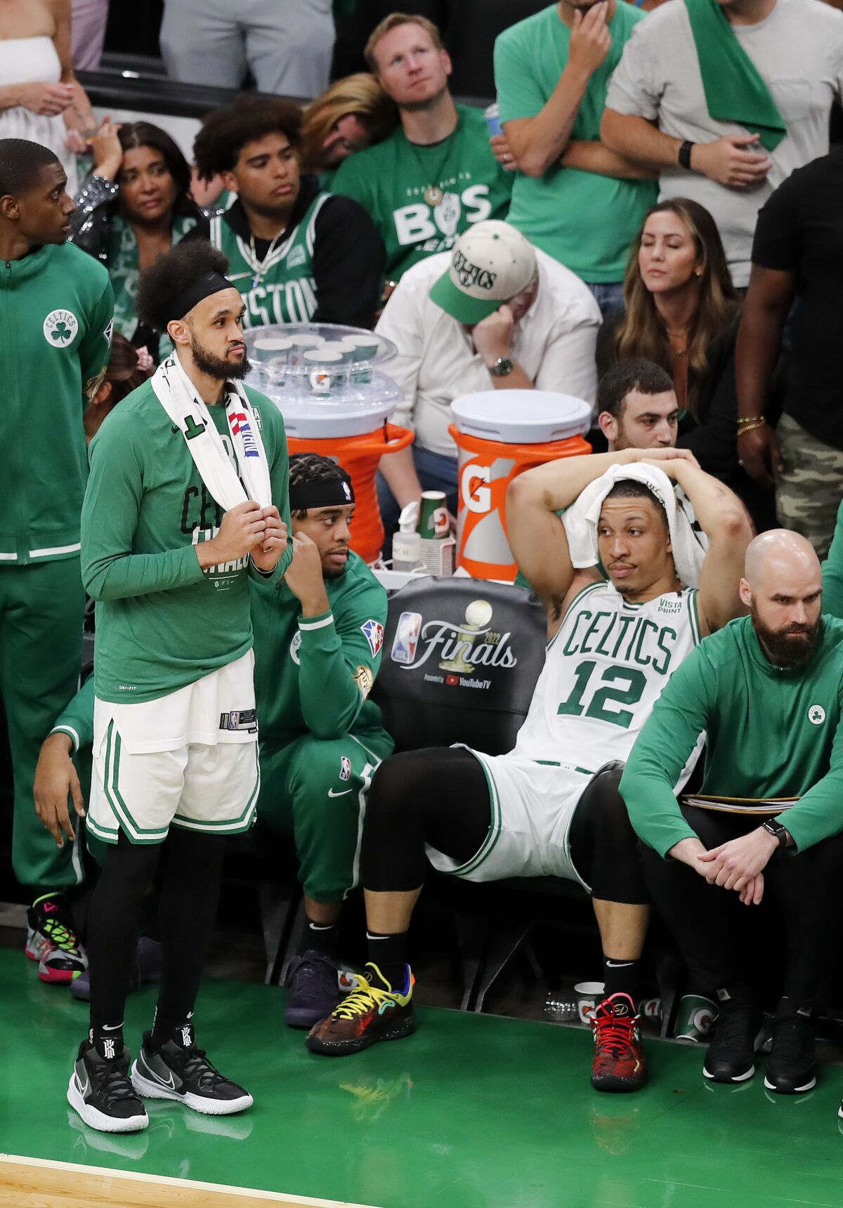 Boston Celtics guard Derrick White, left, and Boston Celtics forward Grant Williams (12) react in the closing second against the Golden State Warriors during Game 6 of basketball's NBA Finals, Thursday, June 16, 2022, in Boston. (AP Photo/Michael Dwyer)