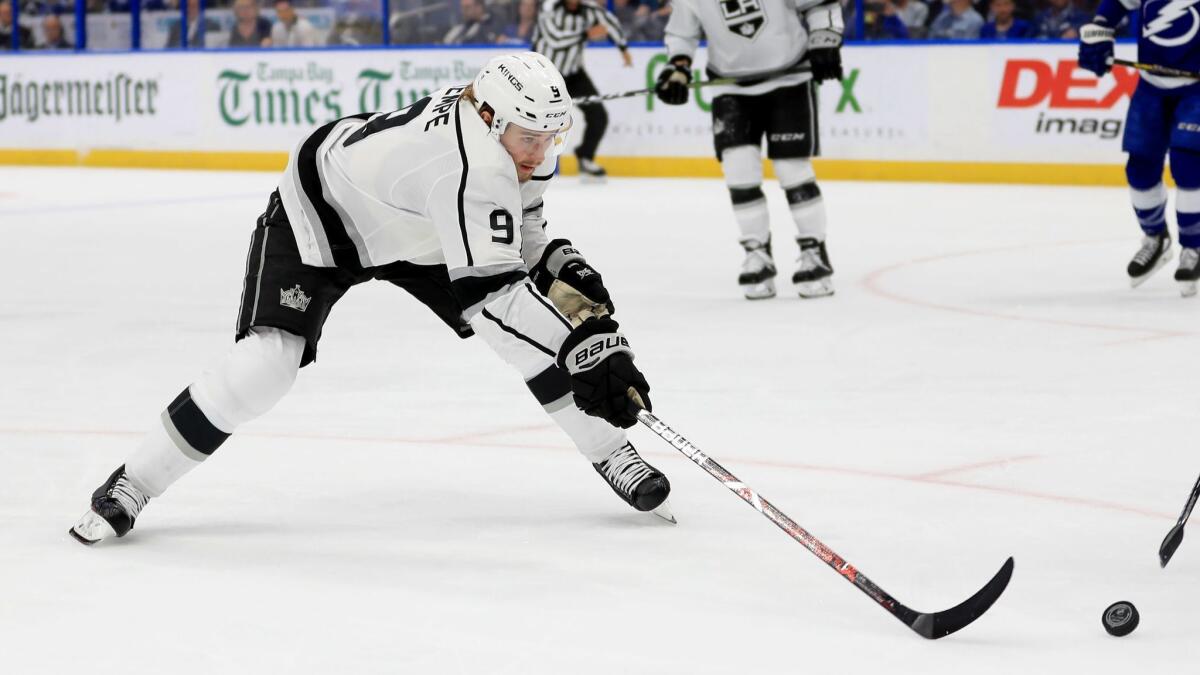 Kings forward Adrian Kempe stretches for the puck during a game against the Tampa Bay Lightning on Feb. 25.