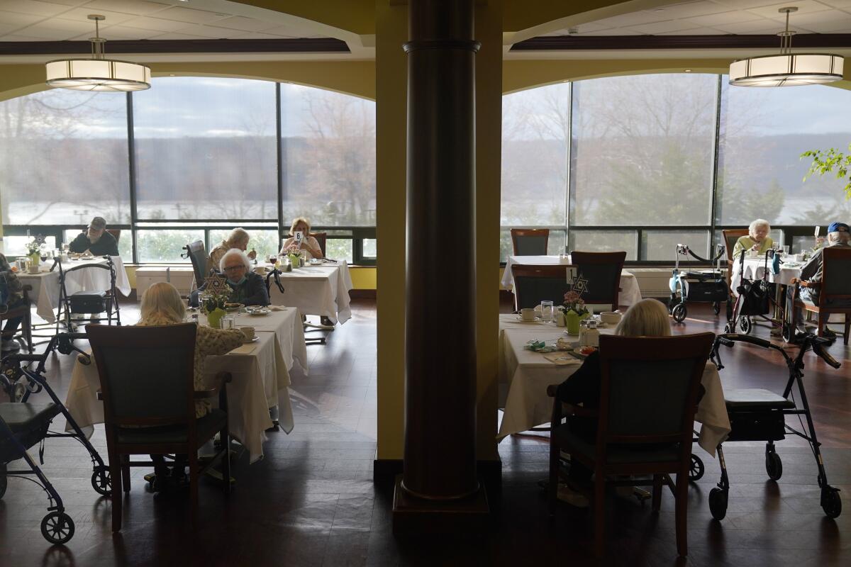 Residents dine socially distant in a New York nursing home.