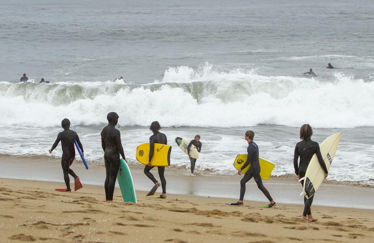 Surfers and boogie boarders view the break at the Wedge in Newport Beach on Thursday.