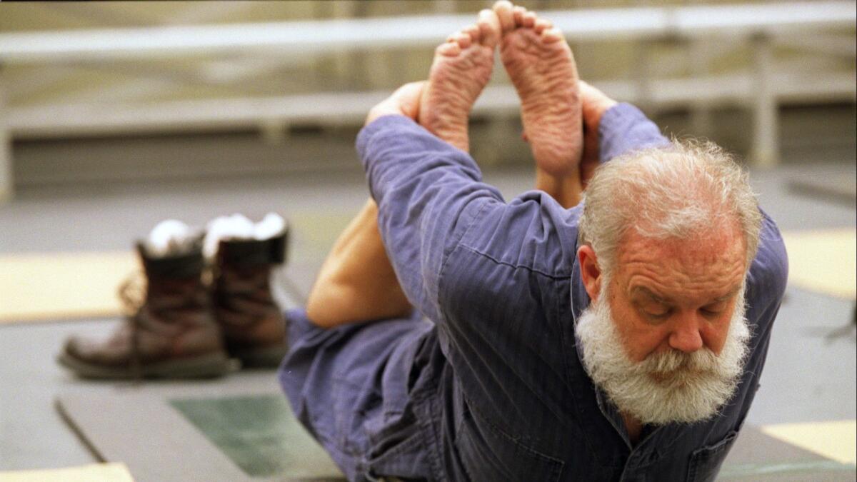 A General Motors employee participates in a yoga class at the plant where he works. A new clinical trial found that employee wellness programs didn't result in measurable improvements in workers' health.
