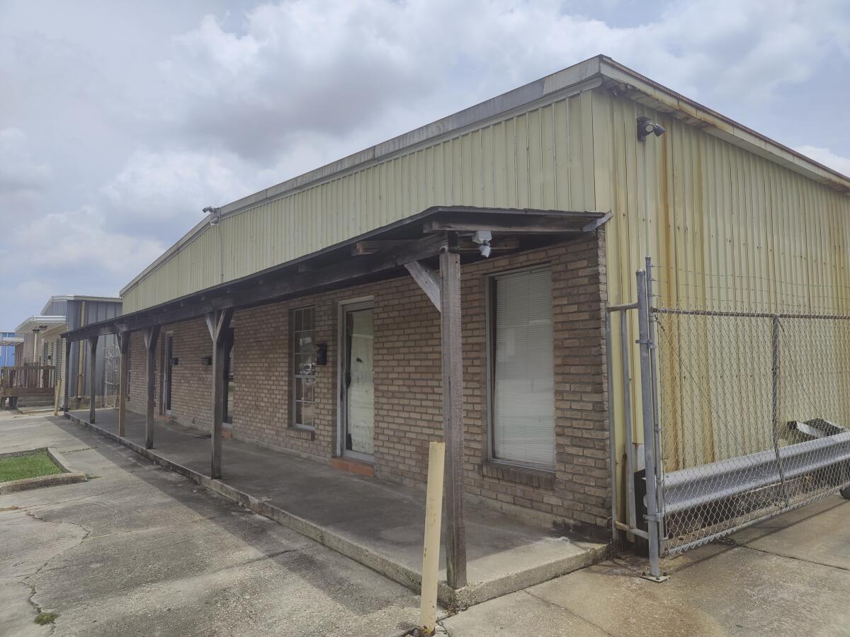 The front awning hangs from the dilapidated unapproved school 