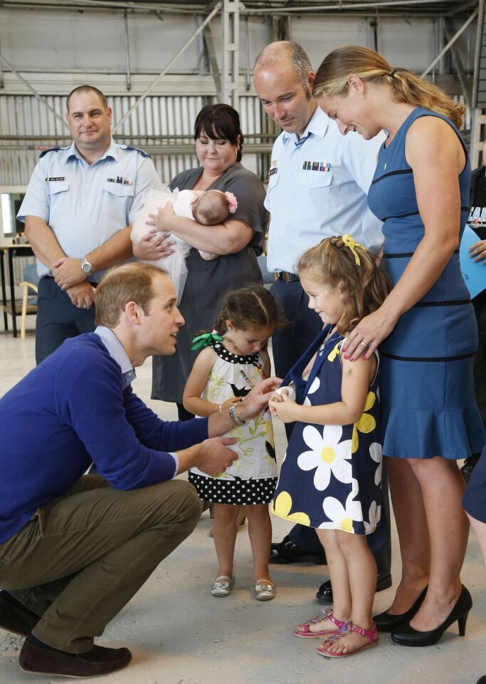 Prince William speaks to Zoe Lloyd, 5, next to Annabel, 3, along with their parents Flight Sgt. Jeremy Lloyd and his wife, Marie, after arriving at Whenuapai Airbase on April 11 in Auckland, New Zealand.