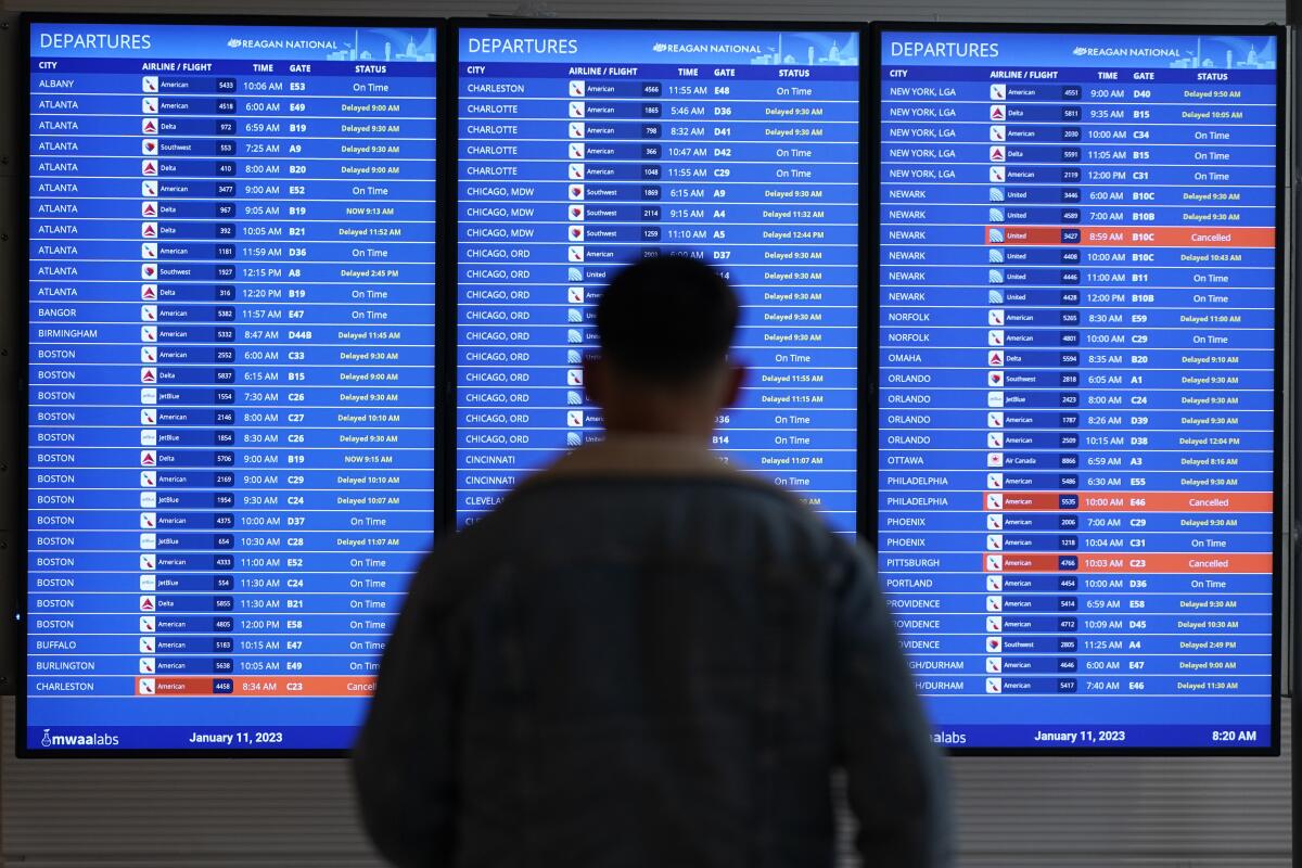 A traveler looks at a flight board