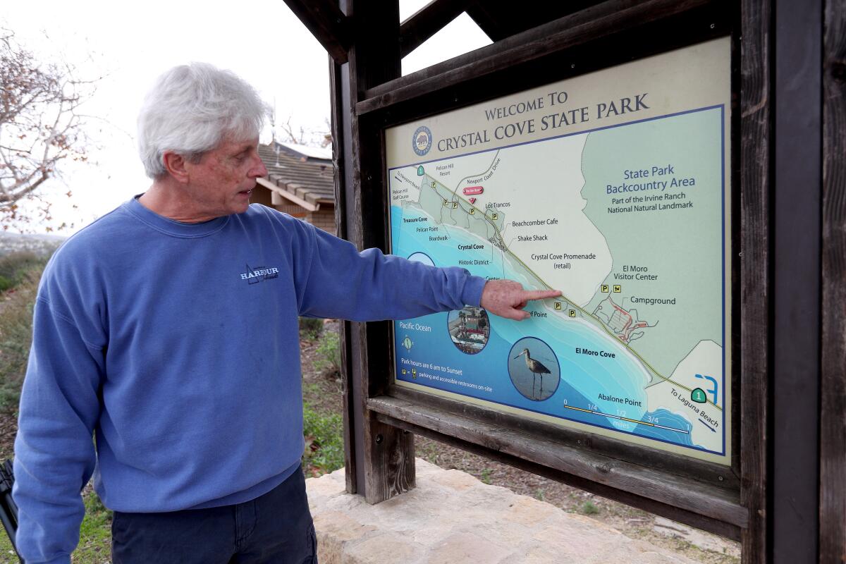 Rick Boufford, a.k.a. "Raven Rick," points out locations that three pairs of ravens use as their territory at Crystal Cove State Park.
