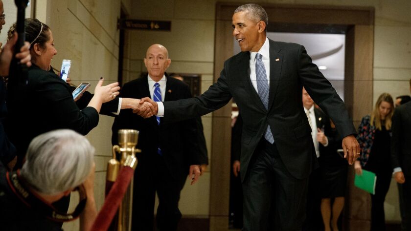 President Barack Obama shakes hands as he leaves a meeting about his signature healthcare law with members of Congress on Jan. 4 on Capitol Hill in Washington.