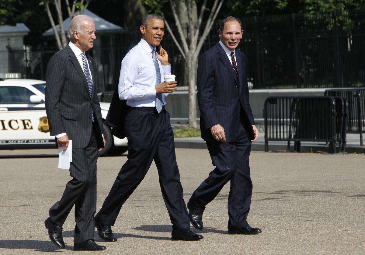 Vice President Joe Biden and President Obama walk with former Procter & Gamble boss Robert McDonald to the White House. Obama named McDonald as his pick to lead the troubled Department of Veterans Affairs.