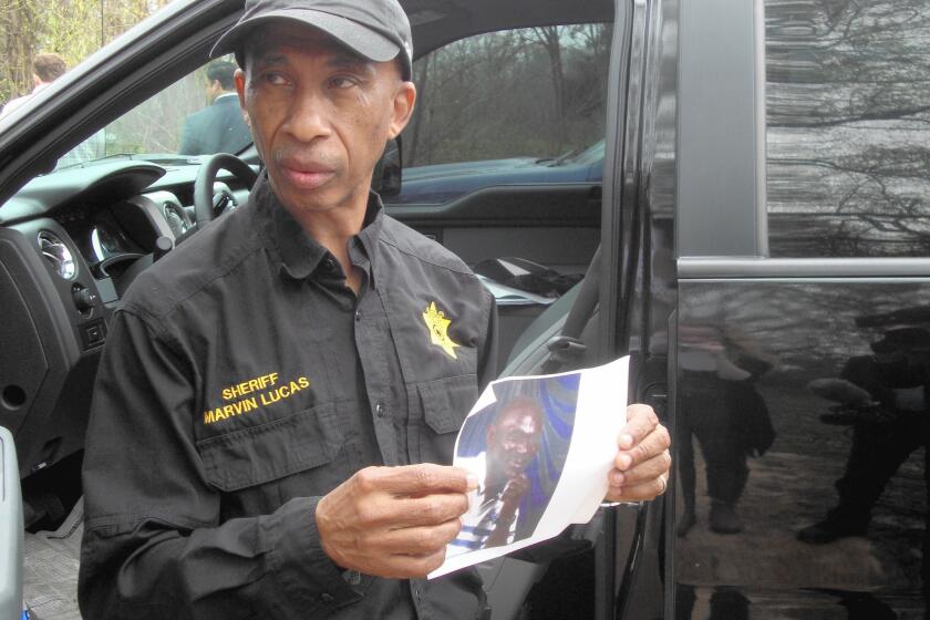 Claiborne County Sheriff Marvin Lucas shows a photo of Otis Byrd, who was found hanging from a tree.