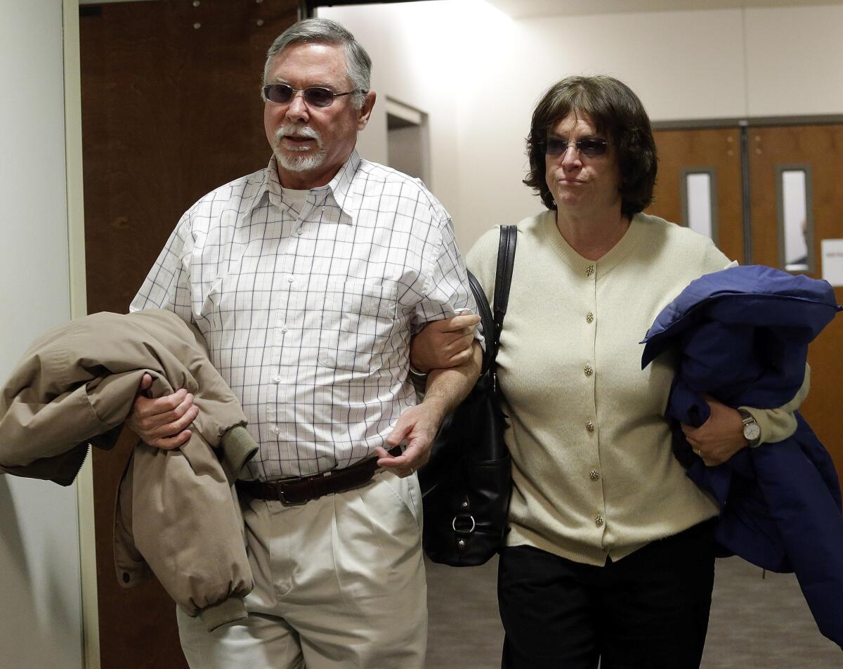 In this March 12, 2013, file photo, Robert and Arlene Holmes, the parents of Aurora theater shooting suspect James Holmes, arrive at district court in Centennial, Colo., for the arraignment of their son. They are asking that their son not receive the death penalty.