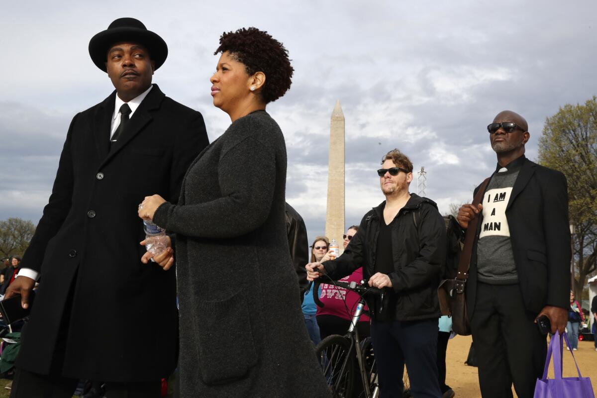 Milton A. Williams, left, pastor of Pennsylvania Avenue AME Zion Church in Baltimore, and Ruth LaToison Ifill join others at the A.C.T. to End Racism rally on the National Mall in Washington, D.C., on Wednesday.