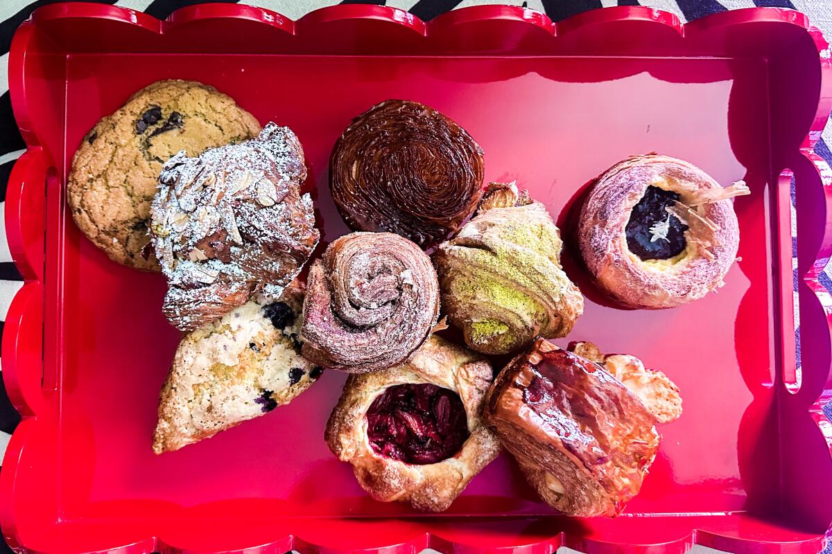 A selection of pastries on a red lacquered tray