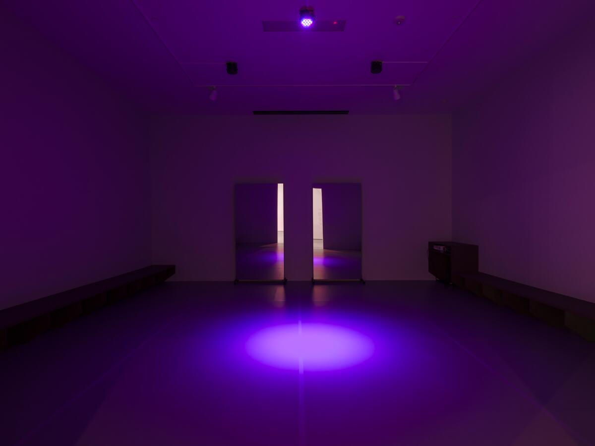 A rehearsal room filled with purple light