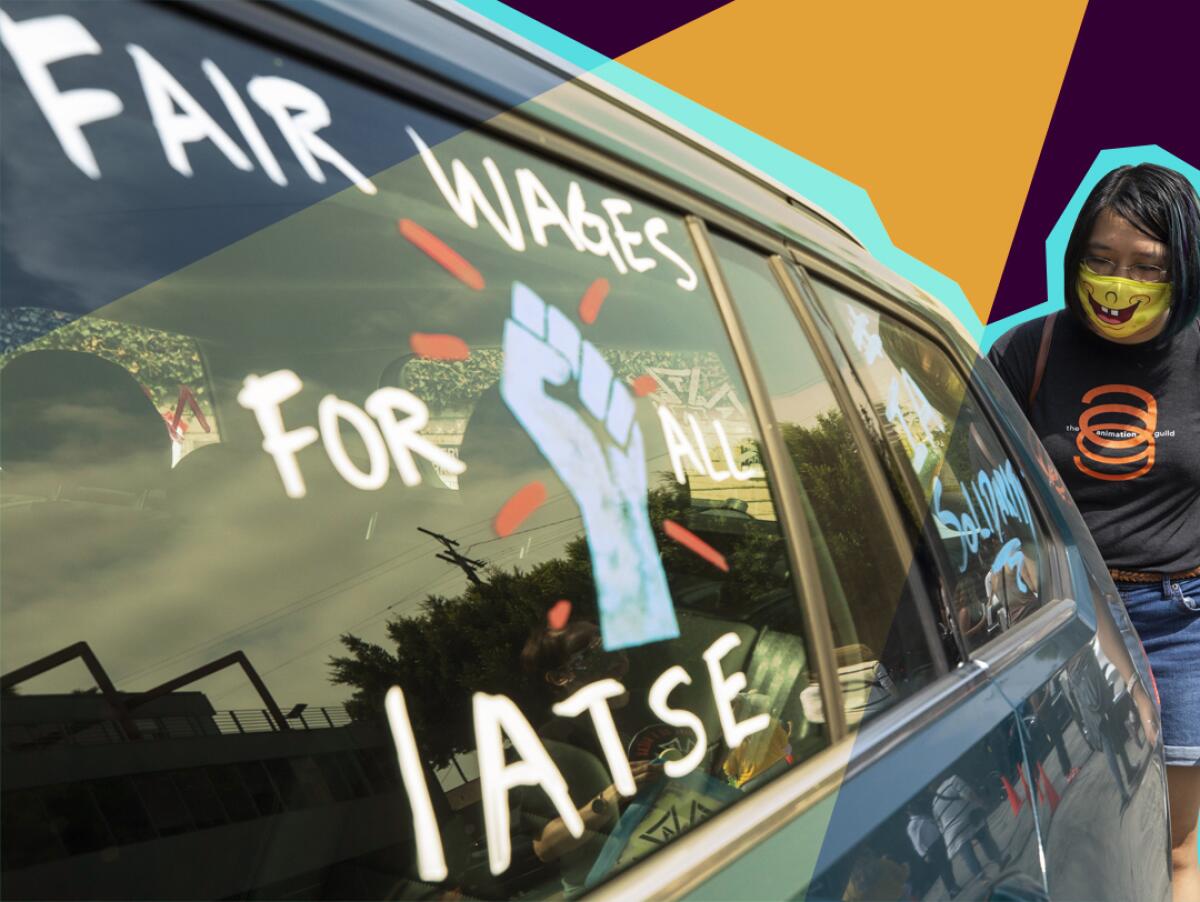A woman stands behind a car with pro-labor signs drawn on the windows.
