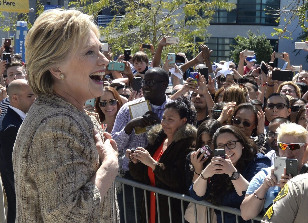 Democratic Presidential candidate Hillary Clinton greets supporters standing in an overflow area outside a rally at Los Angeles Southwest College on Saturday. Clinton was campaigning in advance of the state's June 7 primary.