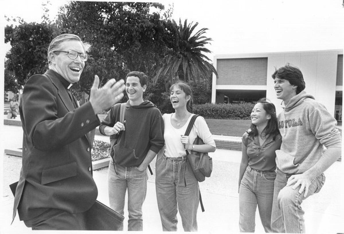 Father Merrifield, with students in 1982, helped transform the campus with the construction of 13 buildings and a focus on recruiting minorities.