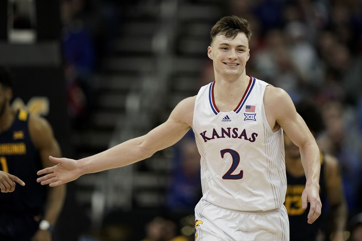 Kansas guard Christian Braun celebrates after a basket during the first half of an NCAA college basketball game against West Virginia in the quarterfinal round of the Big 12 Conference tournament in Kansas City, Mo., Thursday, March 10, 2022. (AP Photo/Charlie Riedel)