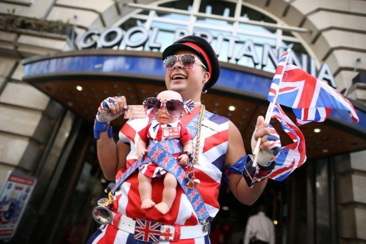 Promotions manager Daniel Obando wears a baby doll wrapped in patriotic decorations.