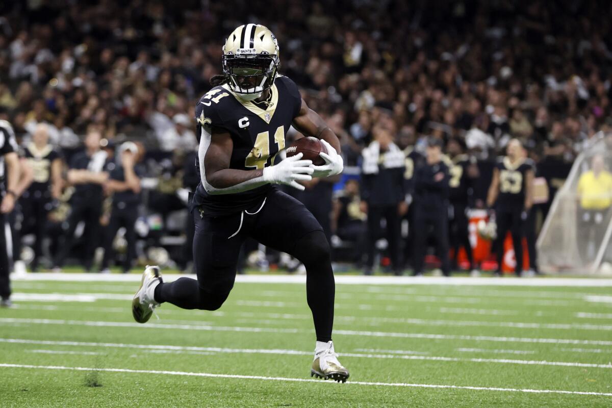 New Orleans Saints running back Alvin Kamara runs in open field.