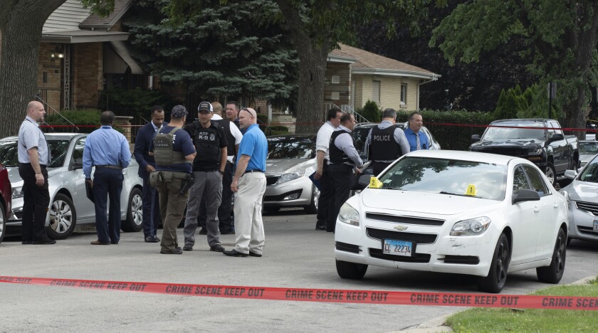 Chicago Police work on a crime scene in a residential neighborhood, Wednesday, June 7, 2021. Three undercover law enforcement officers were shot and wounded Wednesday morning while driving onto an expressway on Chicago’s South Side, and detectives were questioning a “person of interest” about the shooting, police said. The shooting occurred at 5:50 a.m. near the 22nd District police station in the city's Morgan Park neighborhood. (Brian Rich/Chicago Sun-Times via AP)