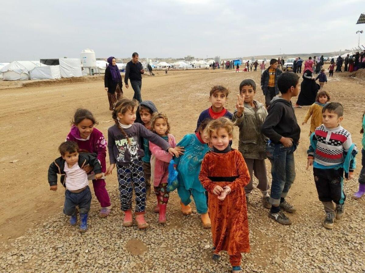 Children gather at the Hassan Sham displaced persons camp near Mosul, Iraq, on Dec. 26.