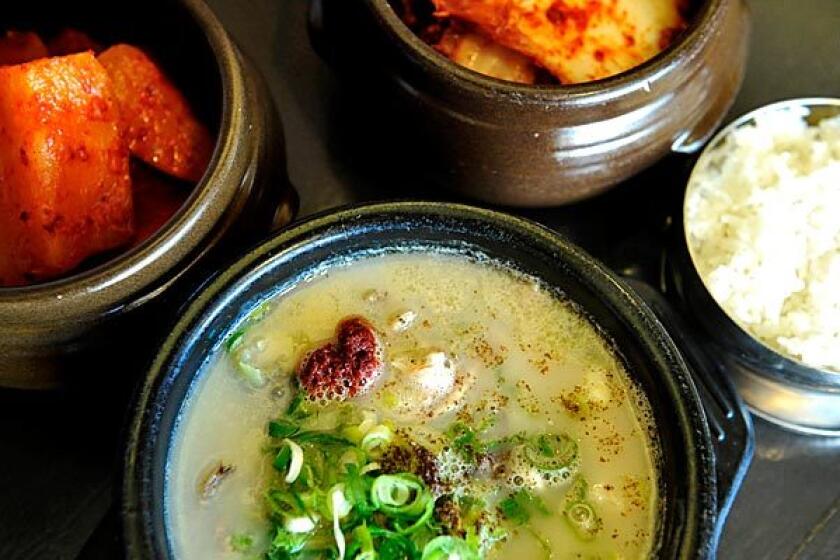 Moobongri Soondae's soondaekook soup is seasoned to taste at the table with ingredients such as spring onions, mustard seed and chile paste.