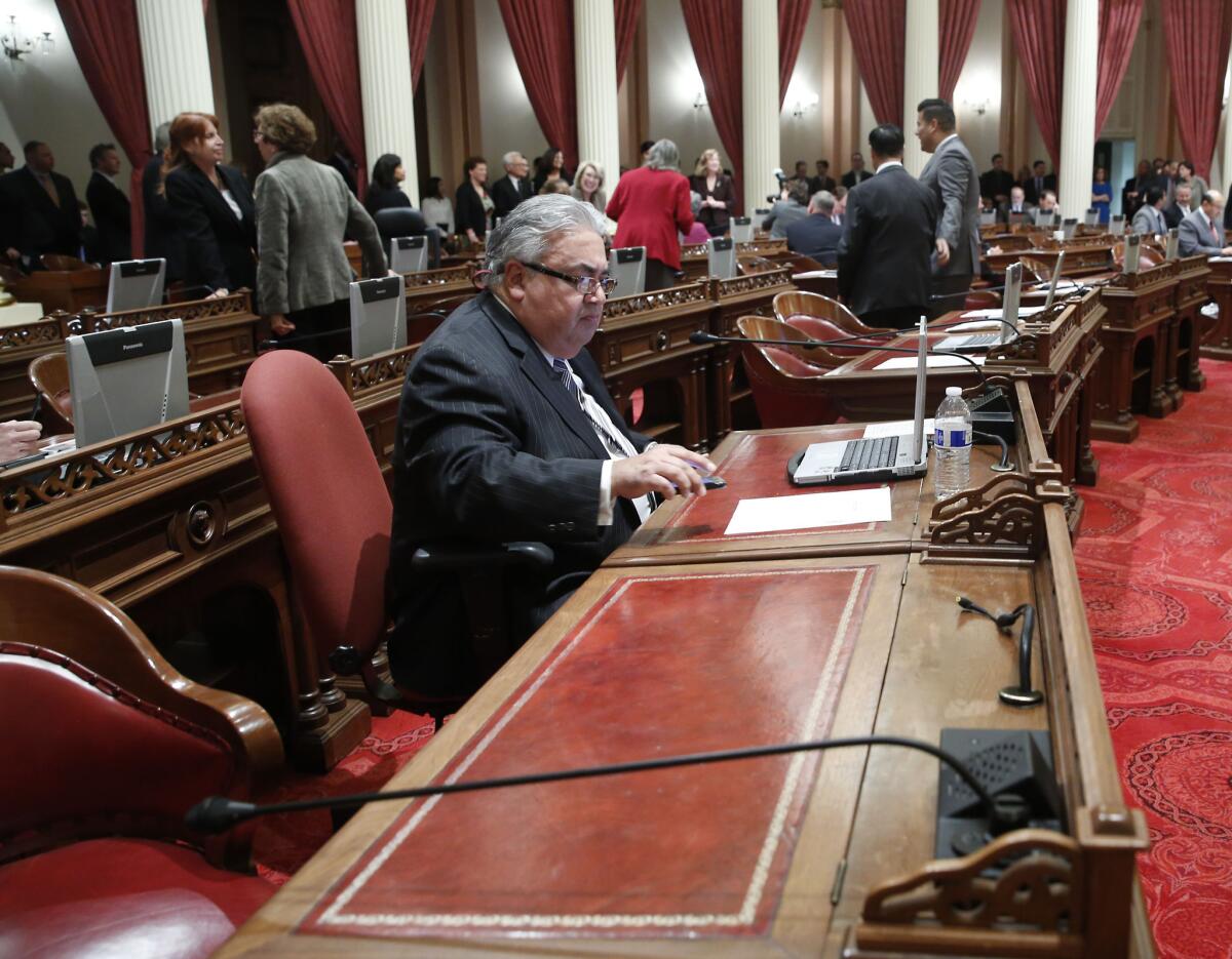 State Sen. Ronald S. Calderon (D-Montebello) works at his desk during a Senate session earlier this month. He was reassigned to the corner desk pending the outcome of a federal corruption investigation.