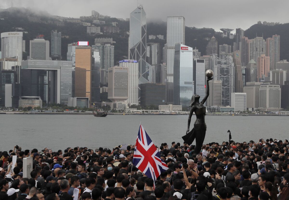 A protester in a crowd carries the British flag in Hong Kong.