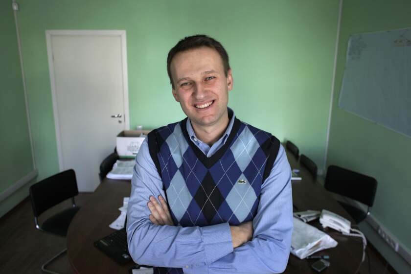 FILE - Russian anti-corruption campaigner and Kremlin critic Alexei Navalny poses in his office in Moscow, Russia on March 17, 2010. In a span of a decade, Navalny has gone from the Kremlin's biggest foe to Russia's most prominent political prisoner. Already serving two convictions that have landed him in prison for at least nine years, he faces a new trial that could keep him behind for another two decades. (AP Photo/Alexander Zemlianichenko, File)