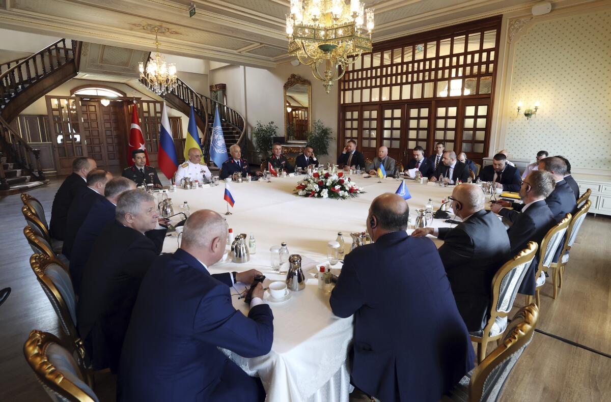 In this handout photo provided by the Turkish Defence Ministry, Russian, left, and Ukranian, top right, delegations meet along with United Nation observers, right, and Turkish Defence Ministry members in Istanbul, Turkey, Wednesday, July 13, 2022. Military delegations from Russia and Ukraine held their governments' first face-to-face talks in months Wednesday as they tried to reach an agreement on a United Nations plan to export blocked Ukrainian grain to world markets through the Black Sea. (Turkish Defence Ministry via AP)