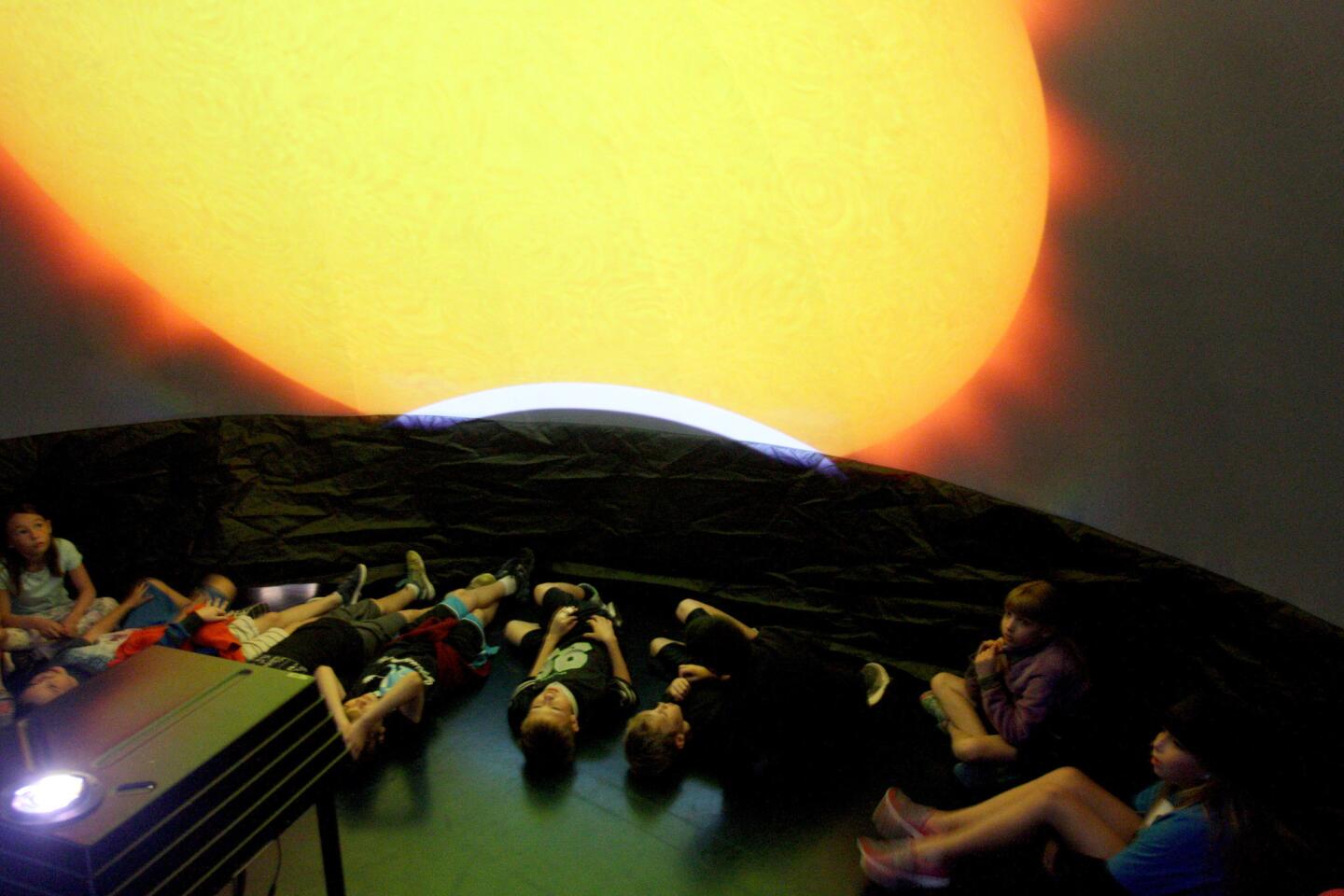 Palm Crest Elementary School third-graders look up from the floor at the sun during a presentation in Jet Propulsion Laboratory's GeoDome, a portable planetarium, at the school in La Cañada Flintridge on Tuesday, Feb. 23, 2016.