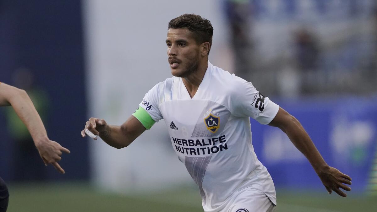Galaxy midfielder Jonathan dos Santos chases after the ball.
