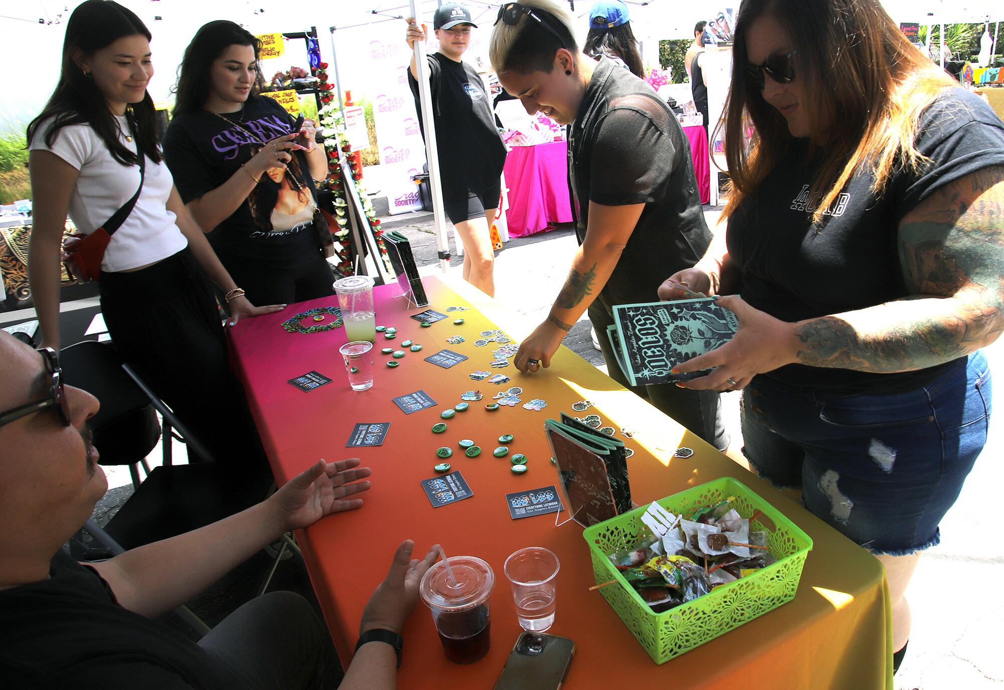 Community members speak to staff at the De Los booth