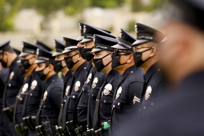 LOS ANGELES, CA - AUGUST 06: LAPD officers, family and friends attend the funeral of Los Angeles Police Department Officer Valentin Martinez, the agency's first sworn employee to die of complications from the COVID-19. The social distance memory service was held at Forest Lawn Hollywood Hills' Hall of Liberty this morning. Martinez was a 13-year veteran of the department and is presumed to have contacted the virus on duty. He was 45 when he died on July 24, 2020, leaving behind his mother, Maria Martinez, his siblings and his domestic partner, Megan Flynn, who is pregnant with their twins. Los Angeles on Thursday, Aug. 6, 2020 in Los Angeles, CA. (Al Seib / Los Angeles Times)