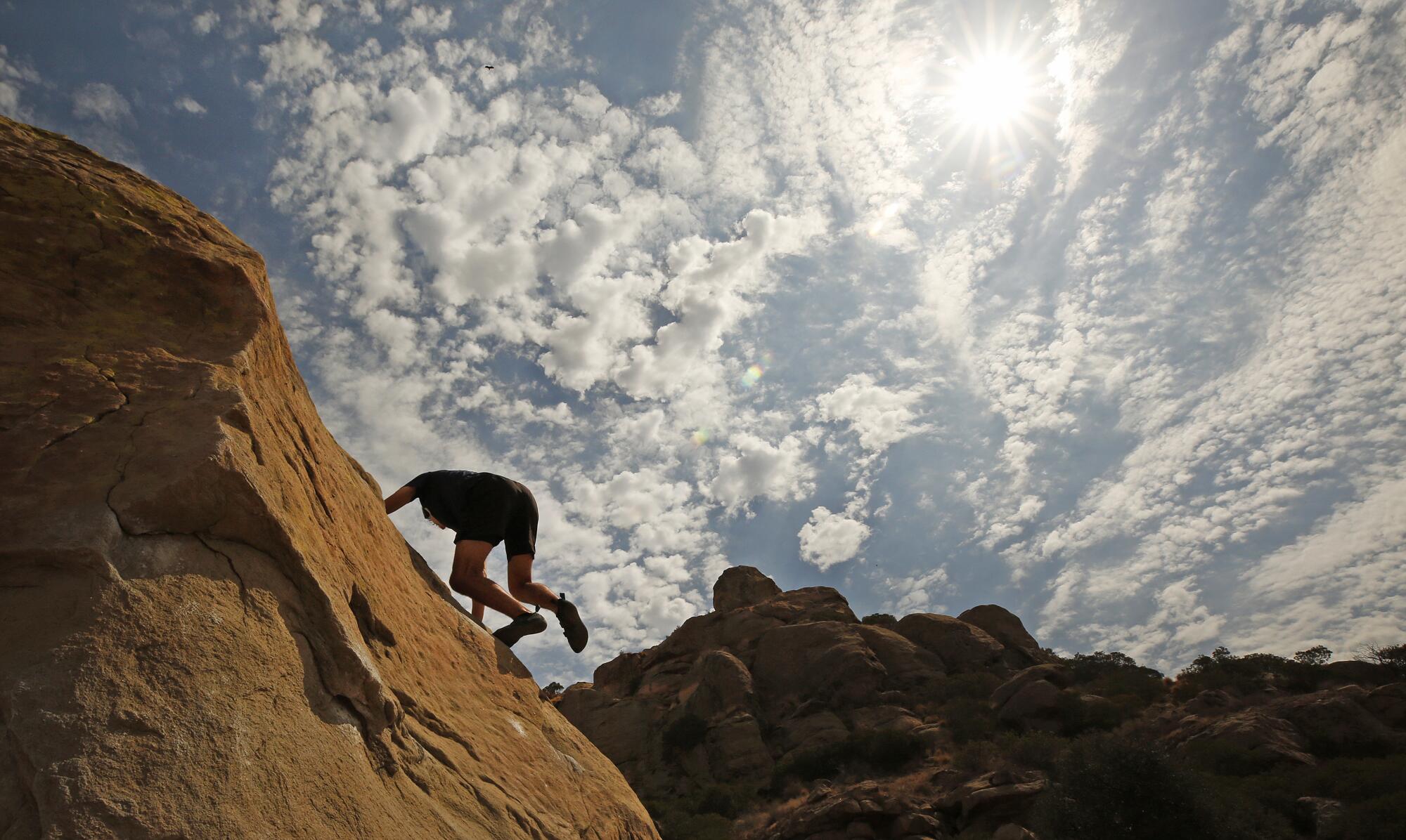 Josh Puchalski practices his bouldering skills at Stoney Point Park in Chatsworth before temperatures began to soar.