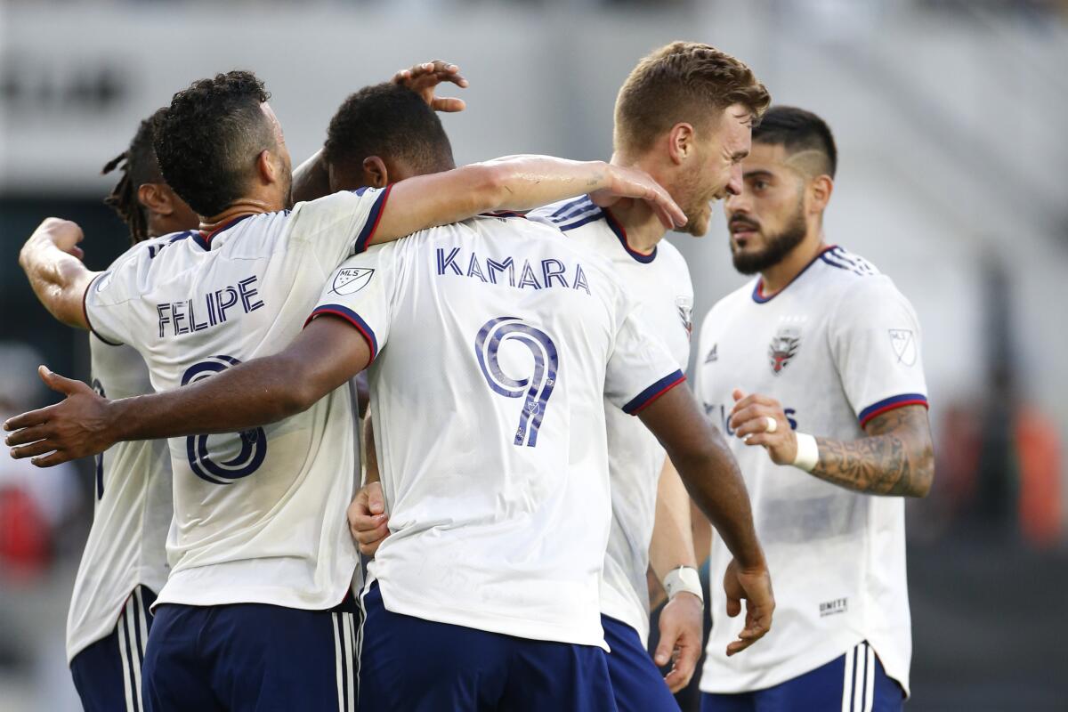 D.C. United players celebrate a goal against the Columbus Crew during the first half of an MLS soccer match Wednesday, Aug. 4, 2021, in Columbus, Ohio. (AP Photo/Jay LaPrete)