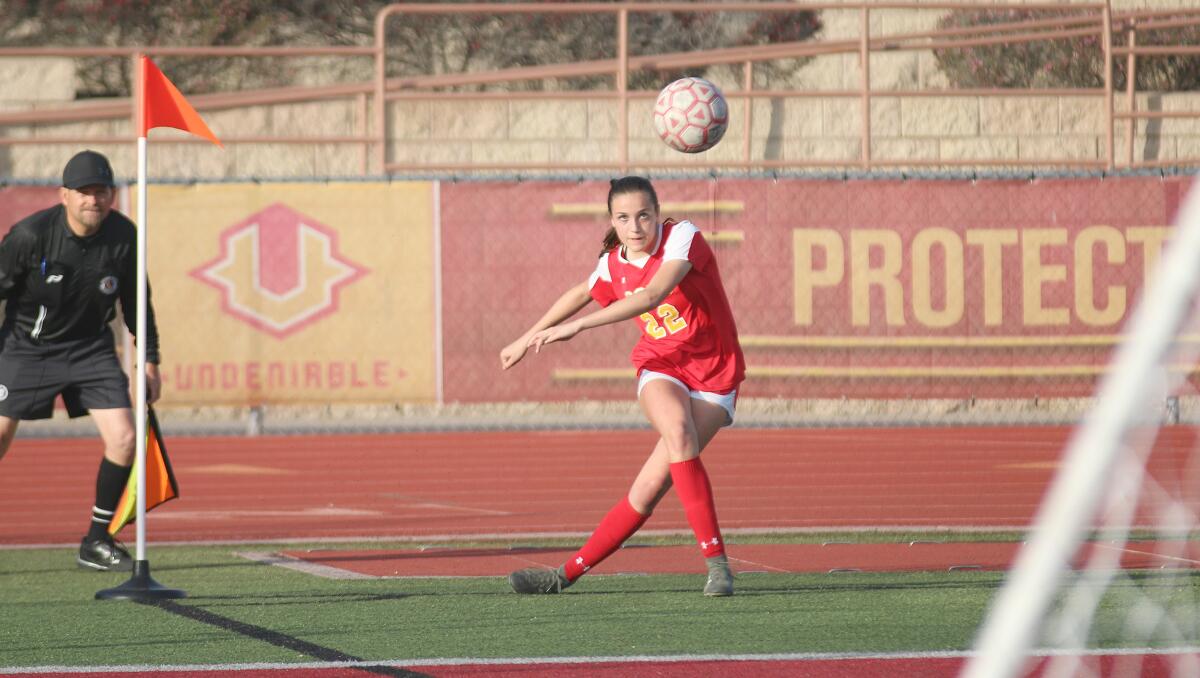 Junior Sophia Aragon launches a corner kick.