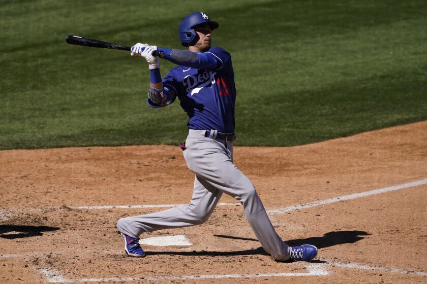 Los Angeles Dodgers' Cody Bellinger hits against the Colorado Rockies during the fourth inning.