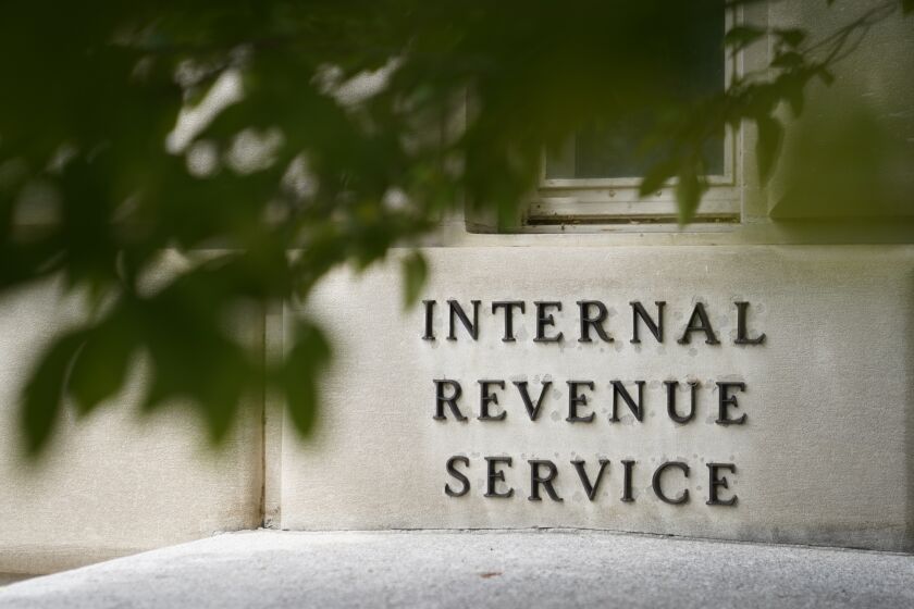 FILE - A sign is displayed outside the Internal Revenue Service building on May 4, 2021, in Washington. While Republicans seek to make good on campaign promises to cut IRS funding through the proposed debt ceiling and budget cuts package now moving through Congress, Democrats are offering assurances that the spending cuts will have little impact on the federal tax collector. (AP Photo/Patrick Semansky, File)