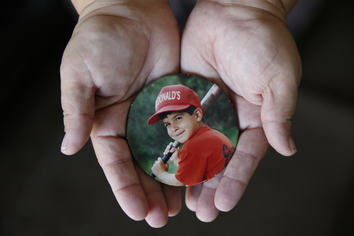 Marissa Cortes-Torres holds a photo of her son, Ramon "Junior" Cortes, 9, who died of a complication of measles, subacute sclerosing panencephalitis, after having contracted measles as a baby.