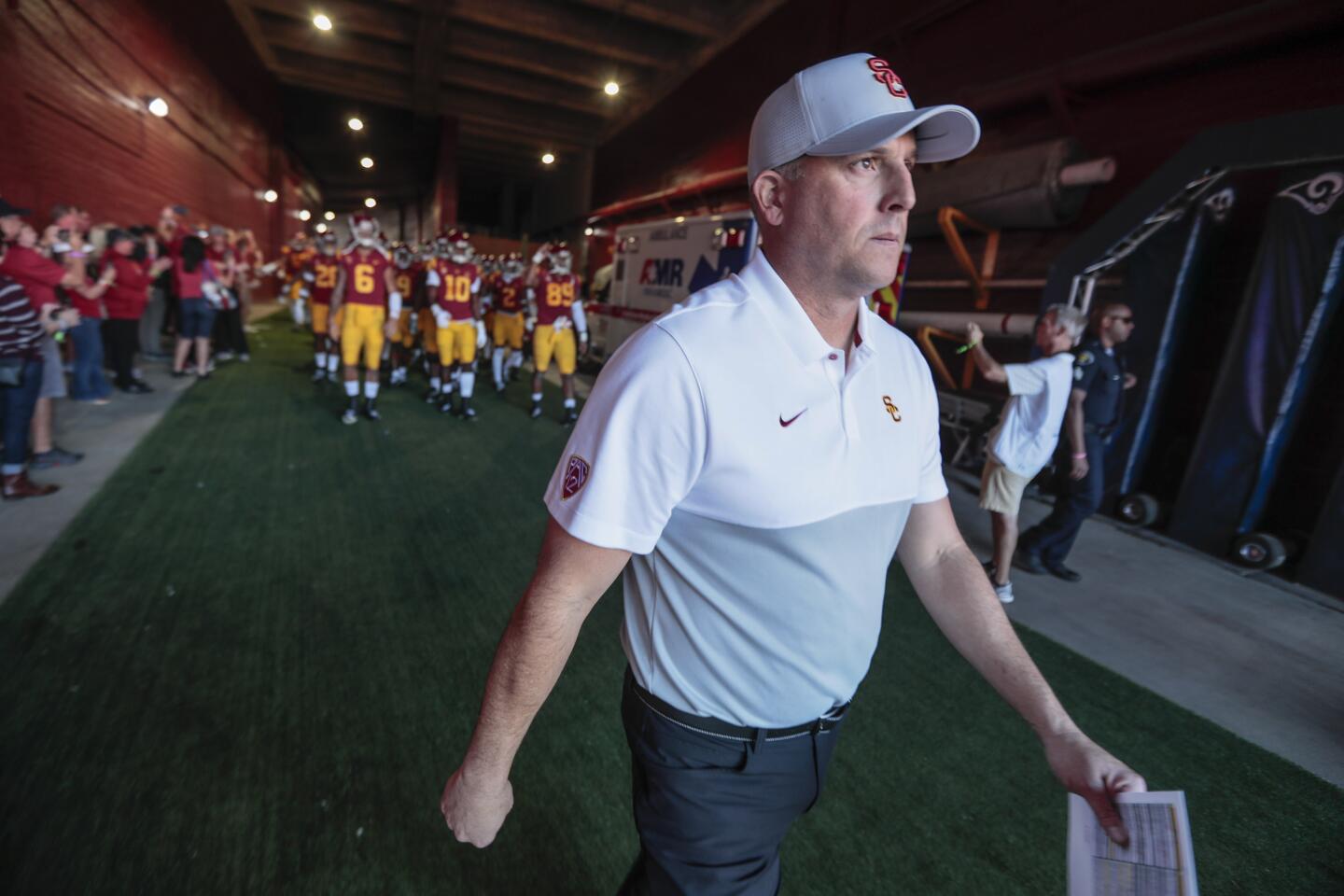 USC head coach Clay Helton leads his team out of the tunnel to play UCLA at the Coliseum on Saturday.