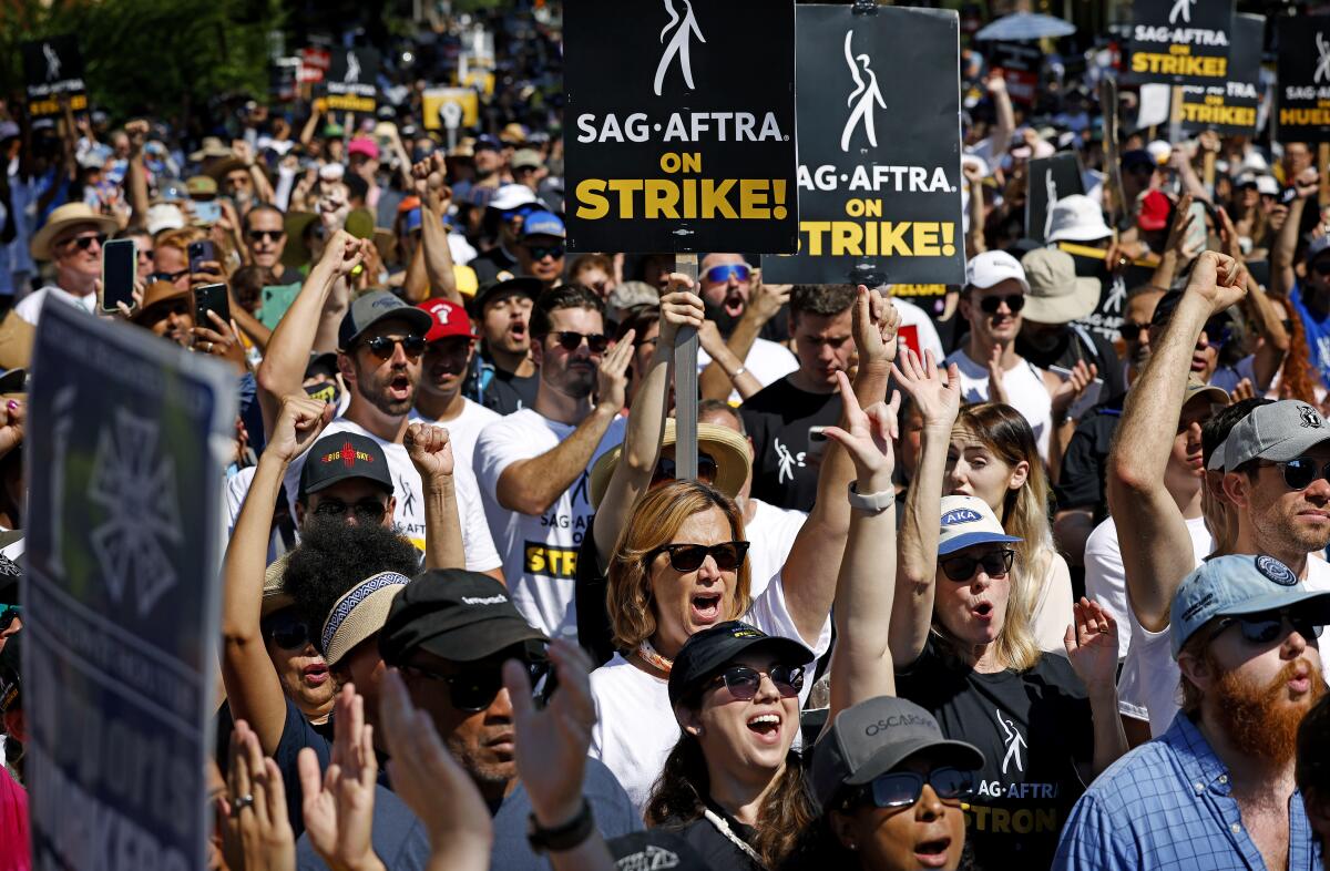 SAG-AFTRA and WGA members rally near Disney Studios.