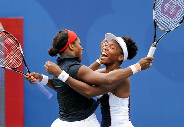 Serena Williams, left, and her sister, Venus, celebrate winning the gold medal in doubles at Beijing, after beating Anabel Medina Garrigues and Virginia Ruano Pascual of Spain. The sisters also won the gold in the event at the Sydney Games.