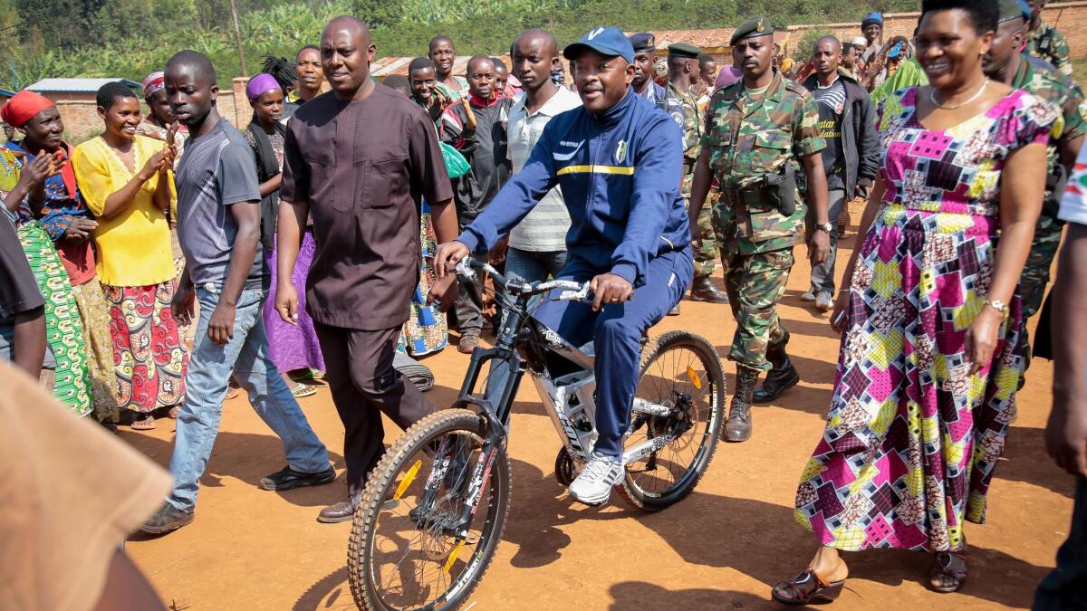 In this July 21, 2015, photo, Burundi President Pierre Nkurunziza, rides a bicycle, in Ngozi, Burundi. An International Criminal Court spokesman confirmed Friday, Oct. 27, 2017, that Burundi will withdraw from the ICC.