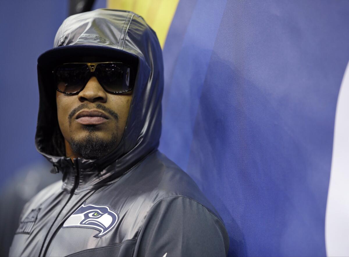 Marshawn Lynch stands against a wall during media day for Super Bowl XLVIII on Jan. 28, 2014, in Newark, N.J.